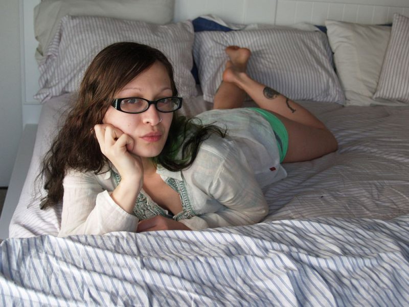 Голая девка в очках разлеглась на двухспальной кровати 30 фото